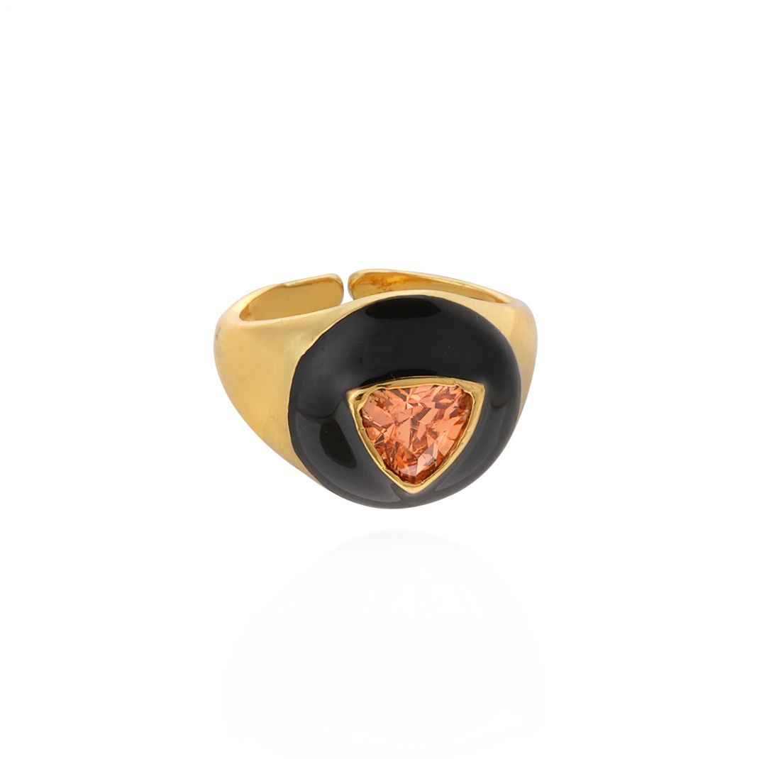 Gold ring with a black band and triangular pink gemstone on a white background