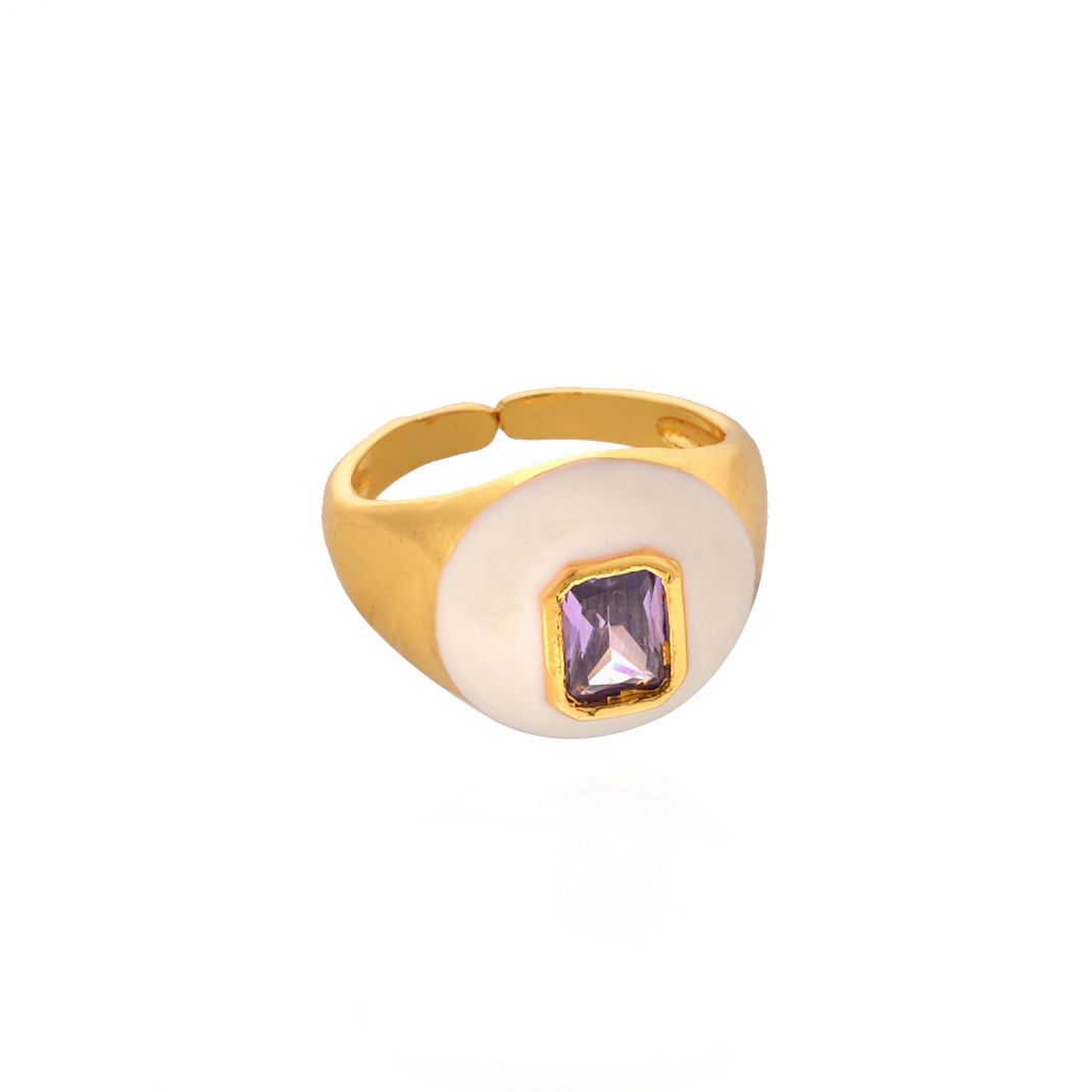 Gold ring with a white stone and purple gemstone on a white background