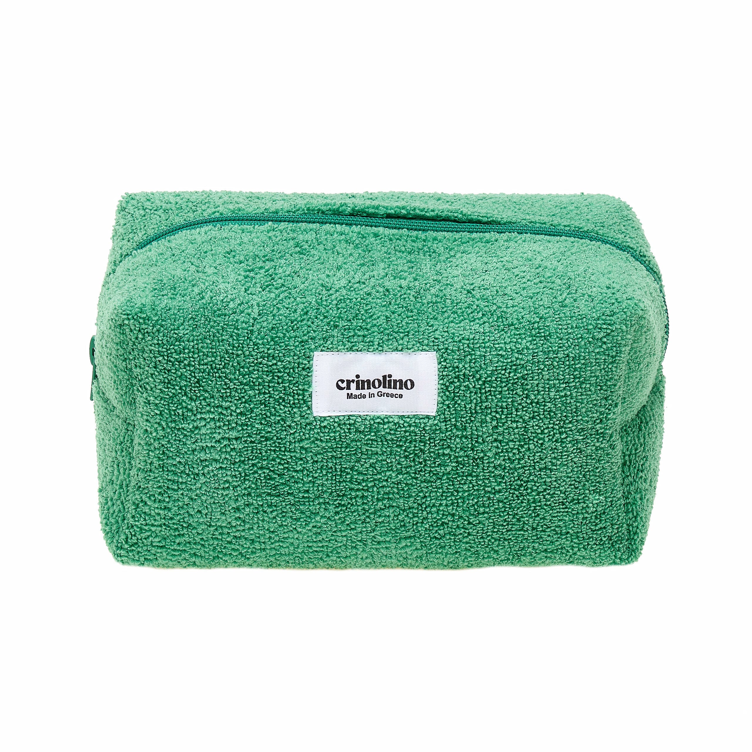 Green towel with a white label on a white background