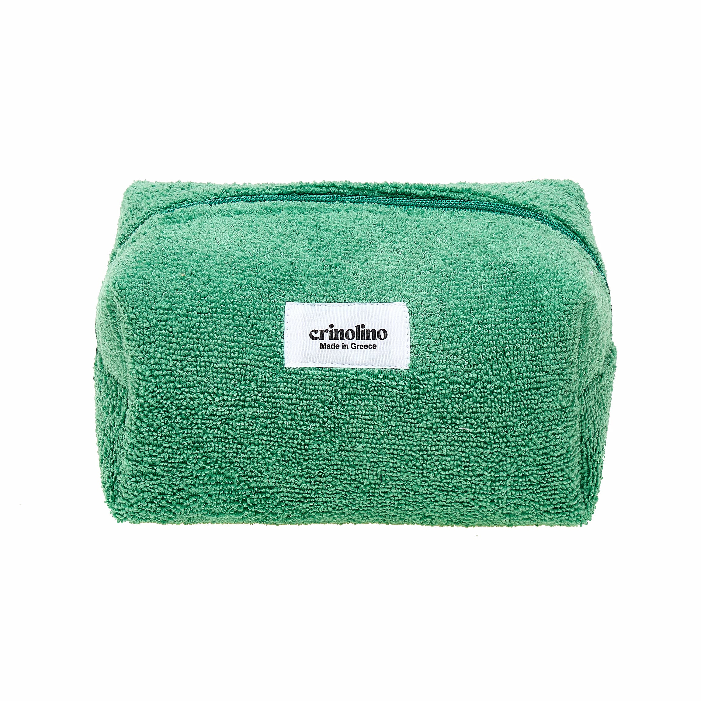 Green towel with a white label on a white background
