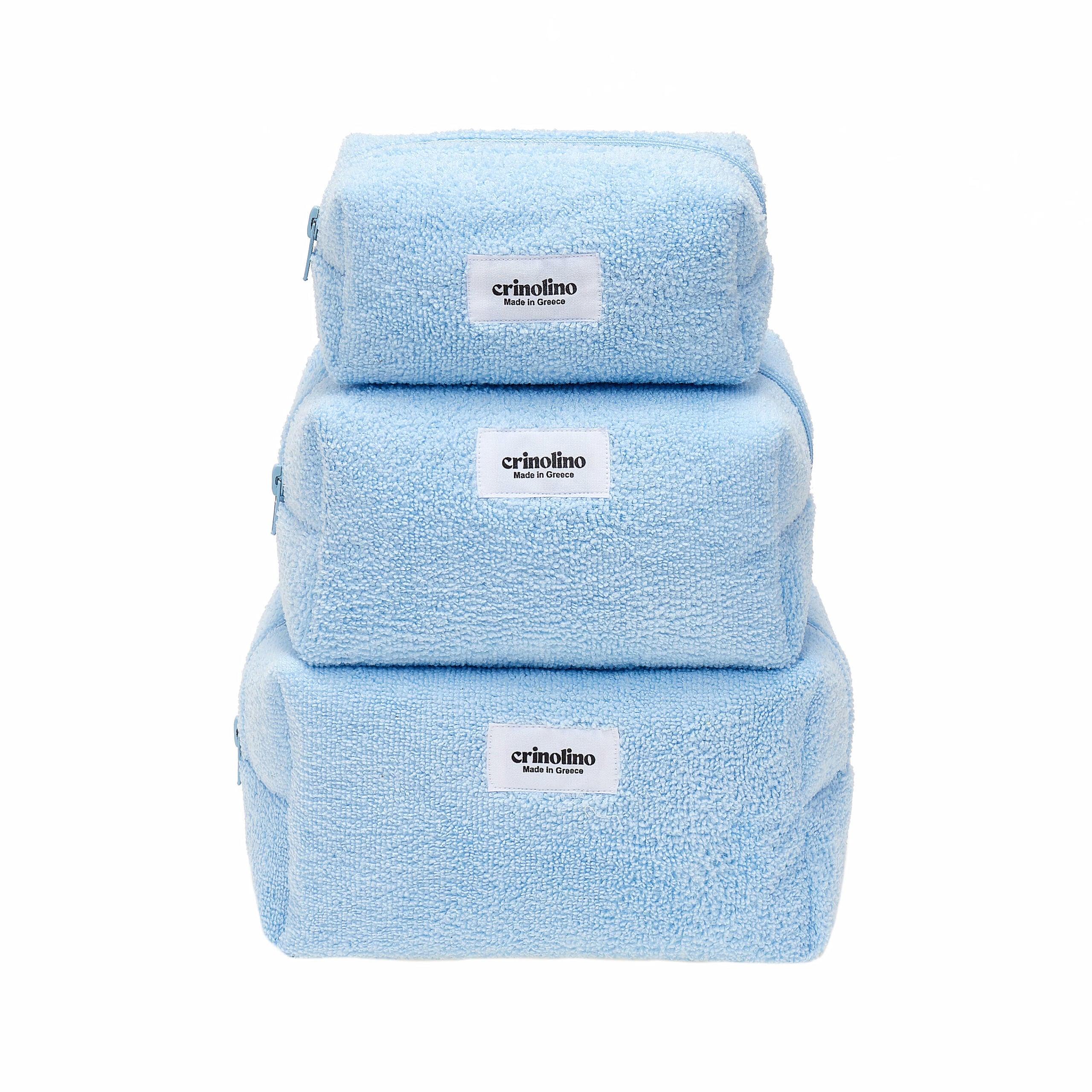 Set of three blue towels stacked on a white background with 'crinolino' branding.