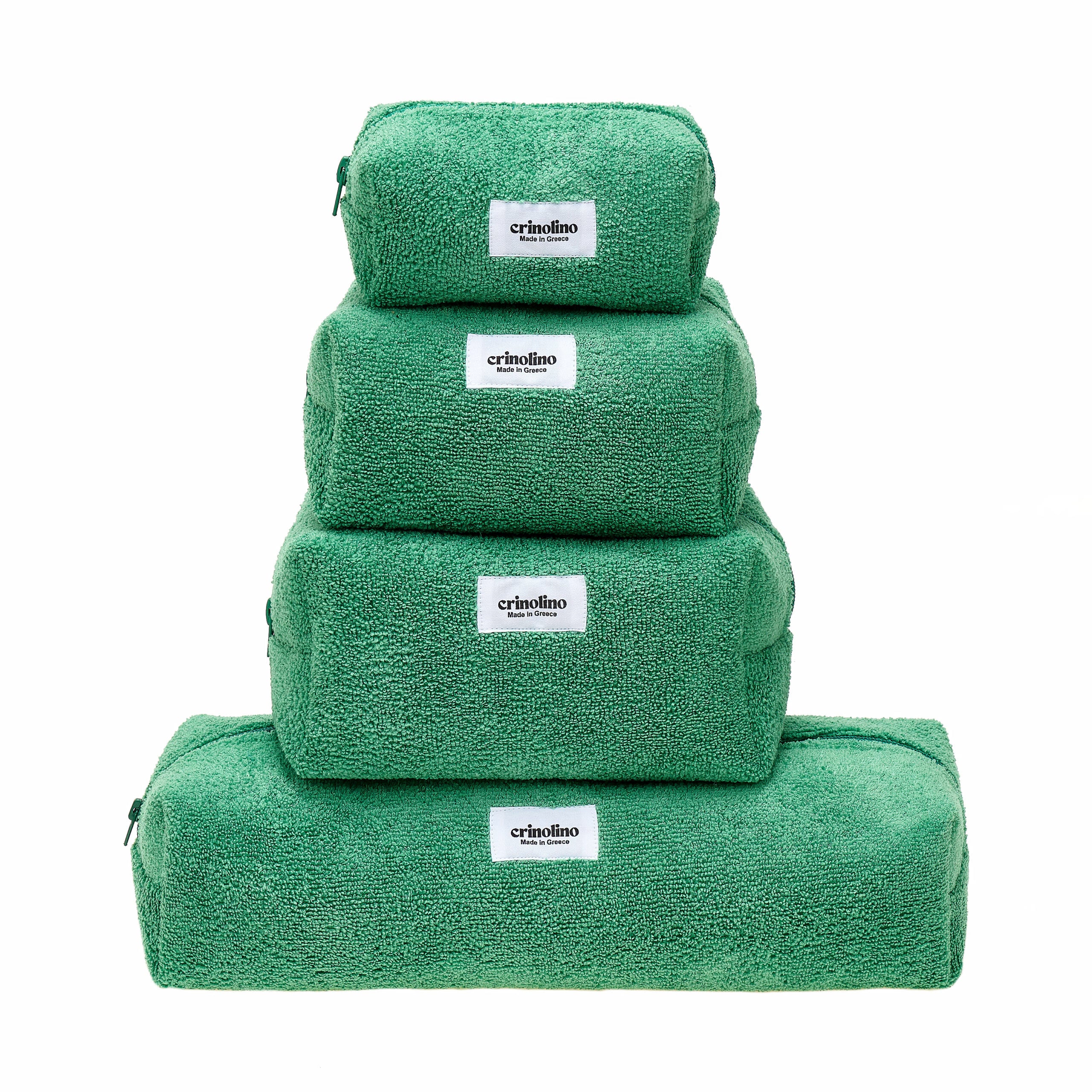 Stack of green towels with 'crinolino' labels on a white background