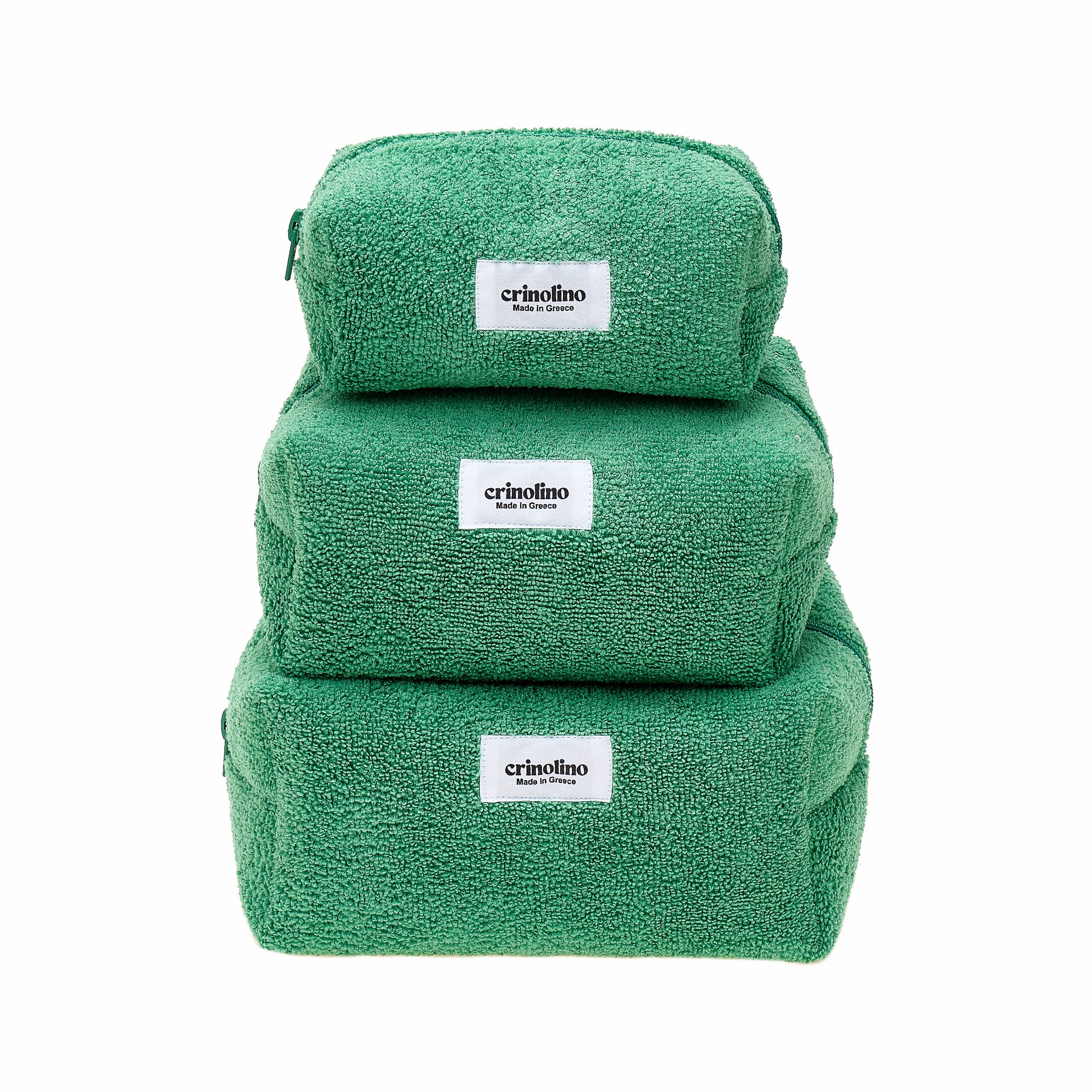 Three green towels stacked on top of each other with 'crinolino' labels on a white background.