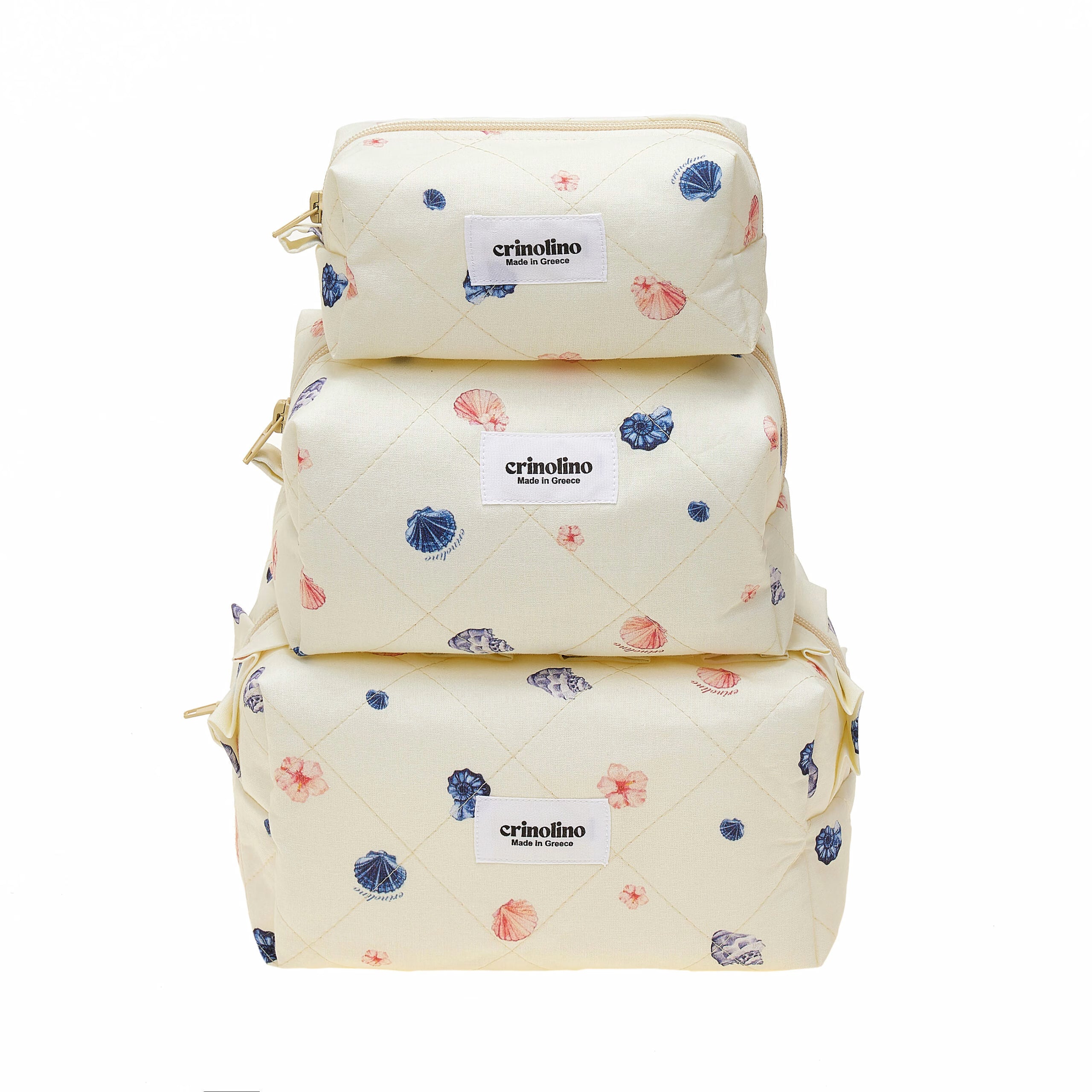Stack of three cream-colored bags with floral patterns and 'crinolino' labels on a white background
