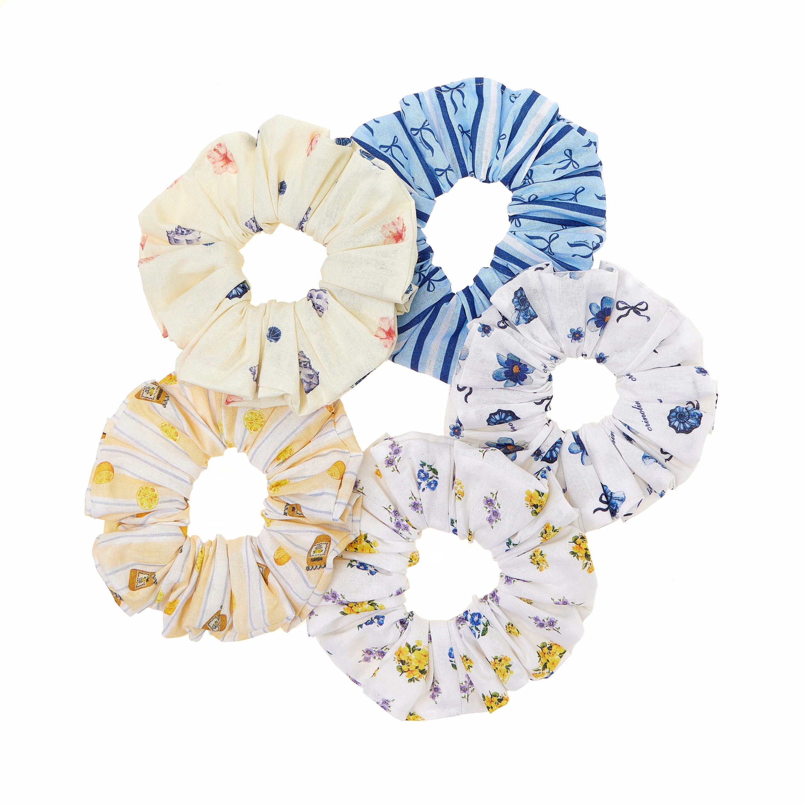 Set of five floral scrunchies in various patterns on a white background