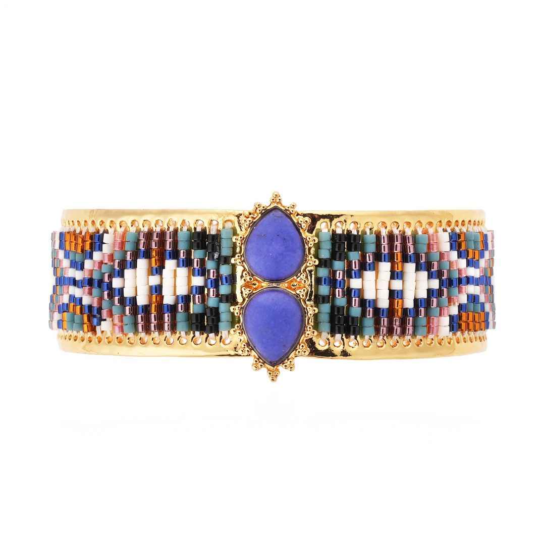 Multicolored beaded bracelet with purple stones on a white background