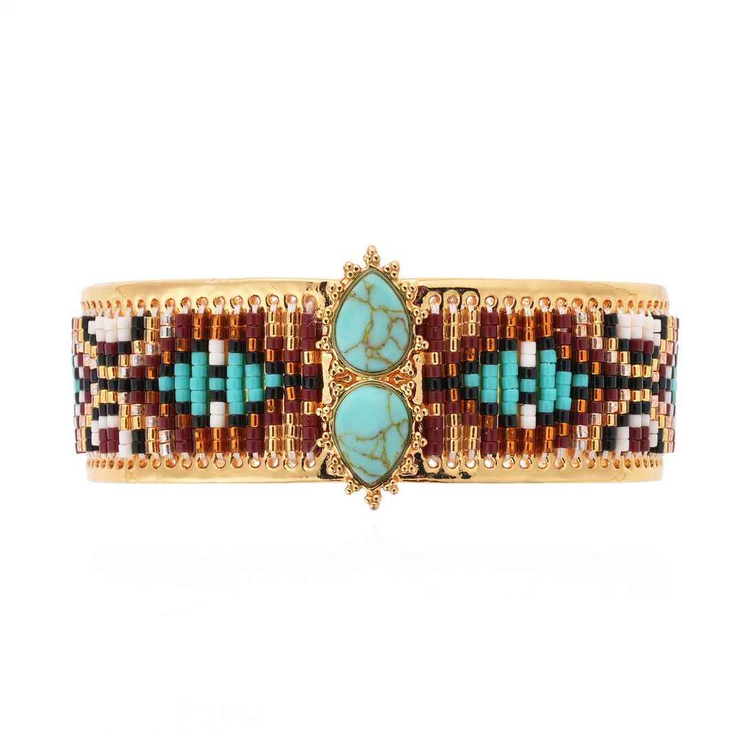 Decorative bracelet with turquoise stones and multicolored beads on a white background