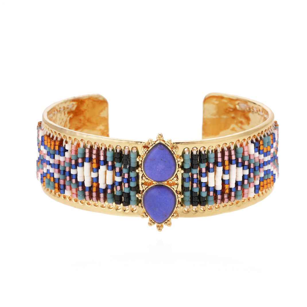 Multicolored beaded cuff bracelet with purple stones on a white background