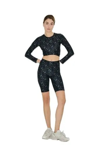 Person wearing a black athletic outfit with white patterns on a white background