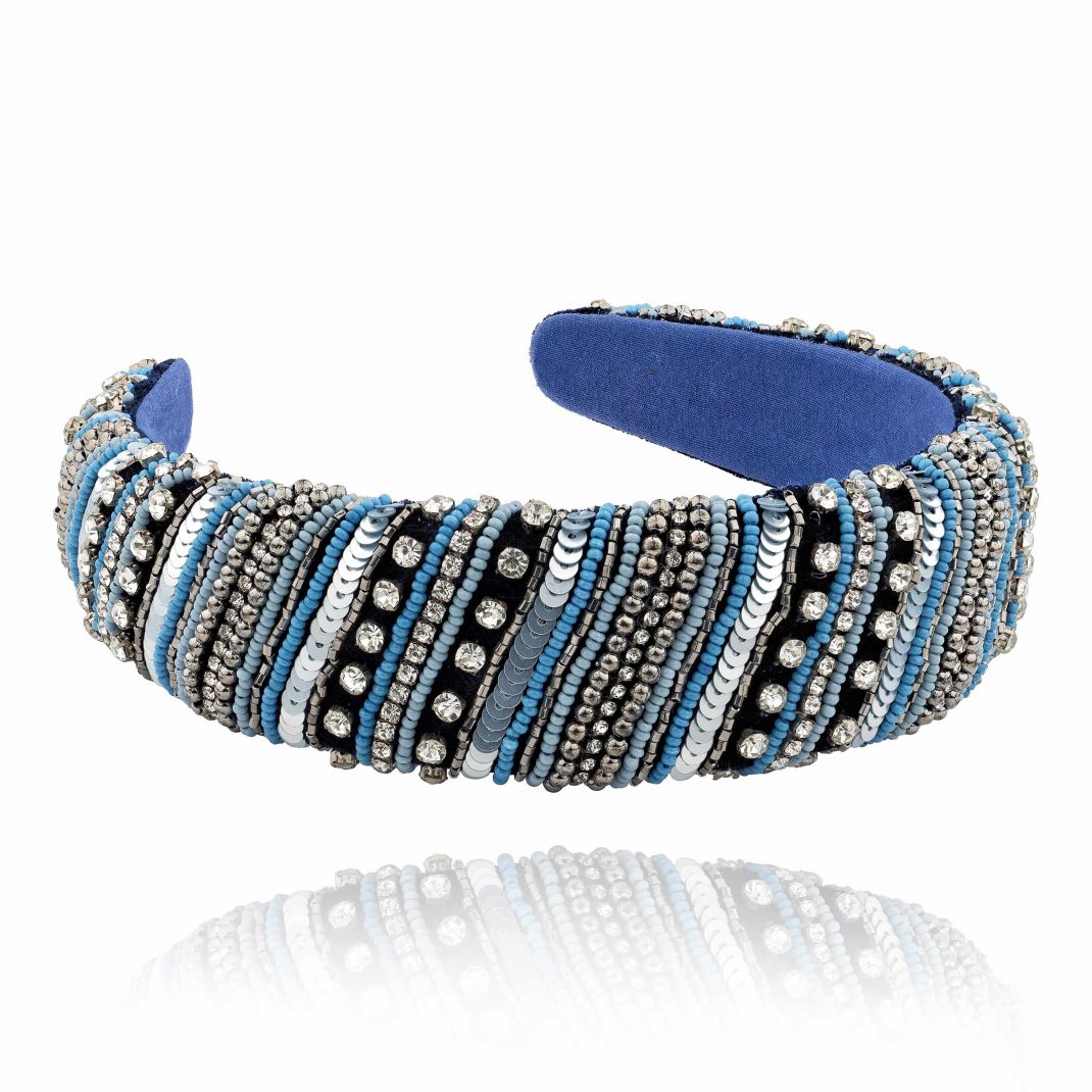 Decorative headband with blue and silver accents on a white background