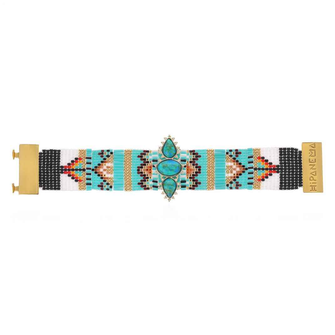 Beaded bracelet with geometric pattern and turquoise stones on a white background