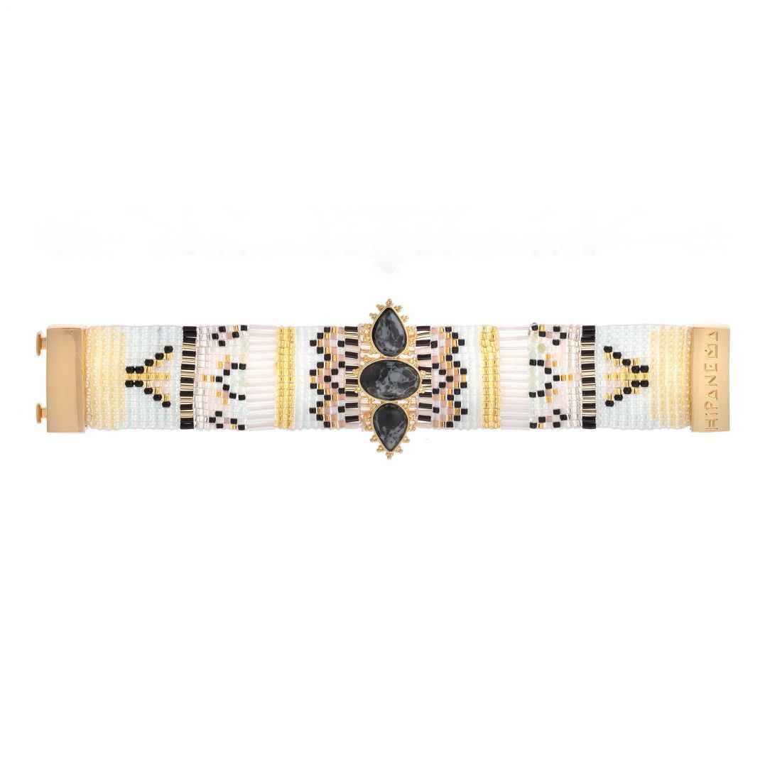 Bracelet with geometric pattern and black stones on a white background