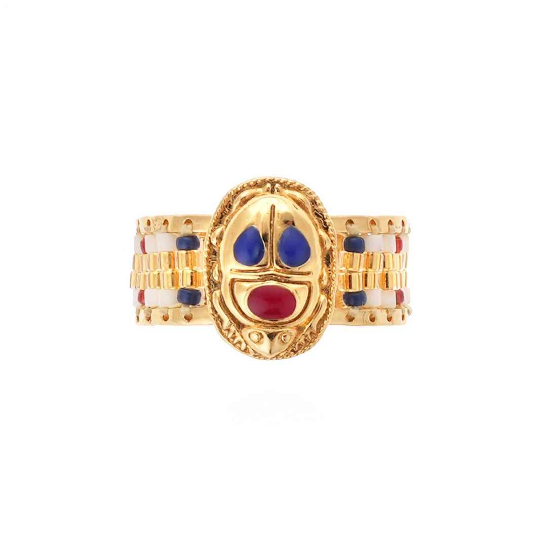 Gold ring with colorful design on a white background