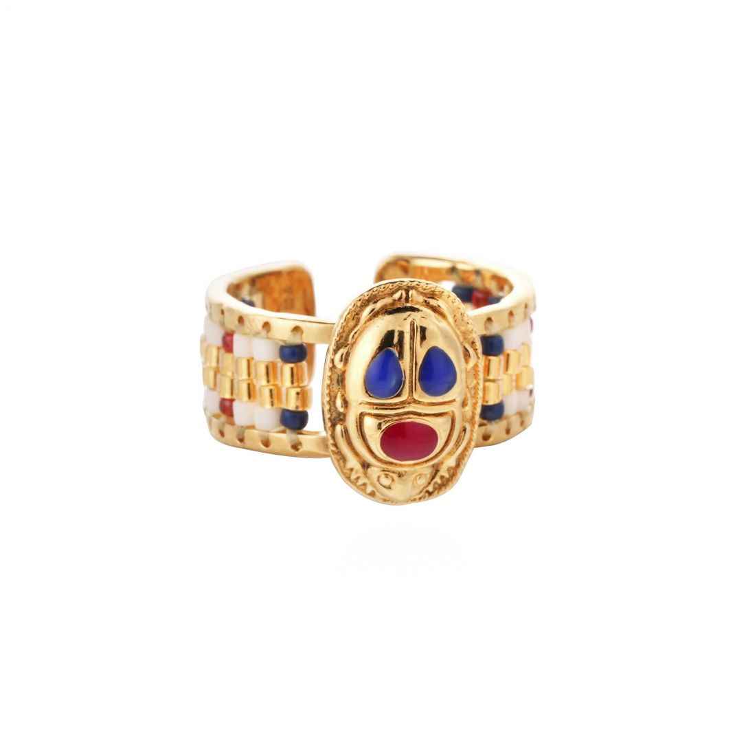 Gold ring with colorful design on a white background