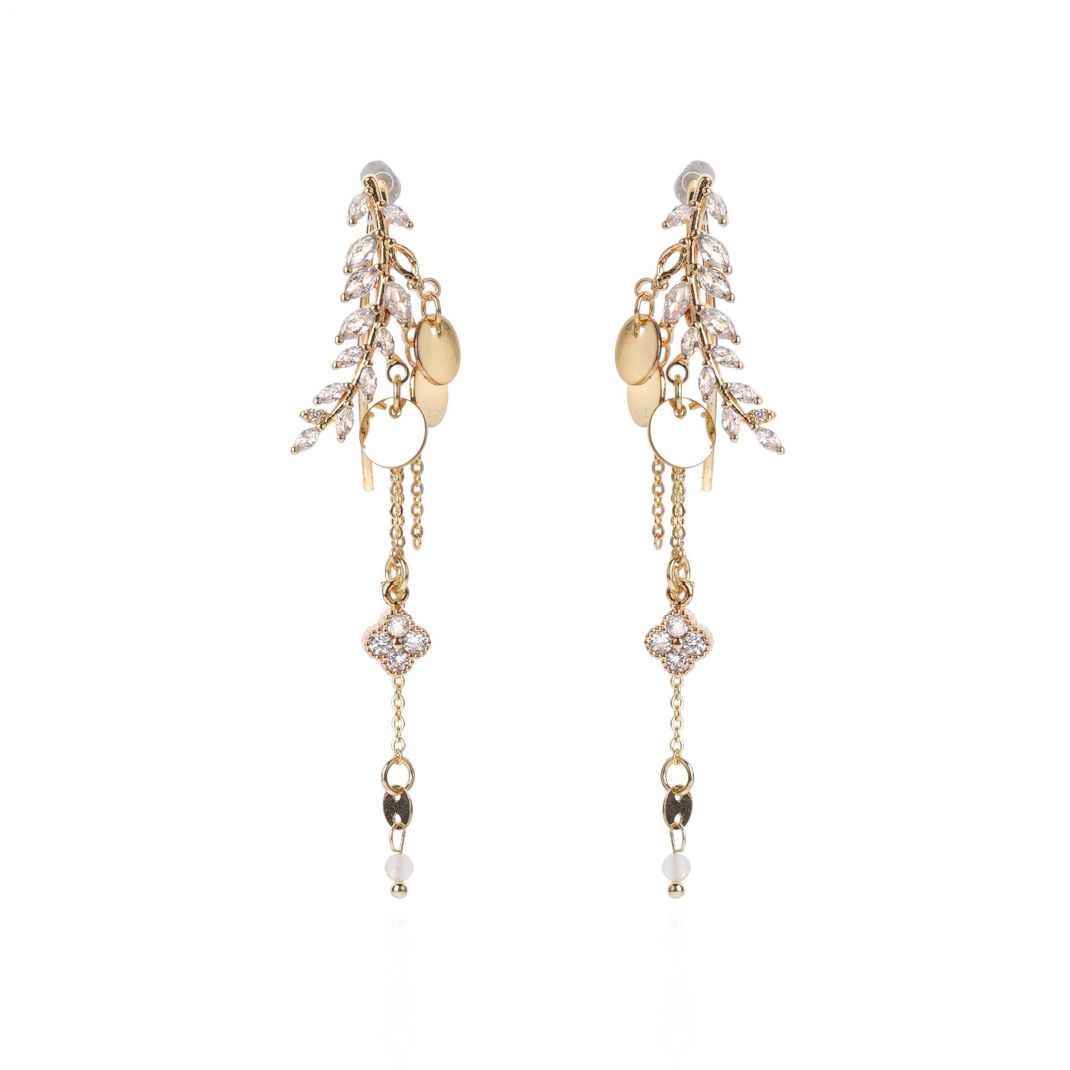Gold and pearl drop earrings on a white background