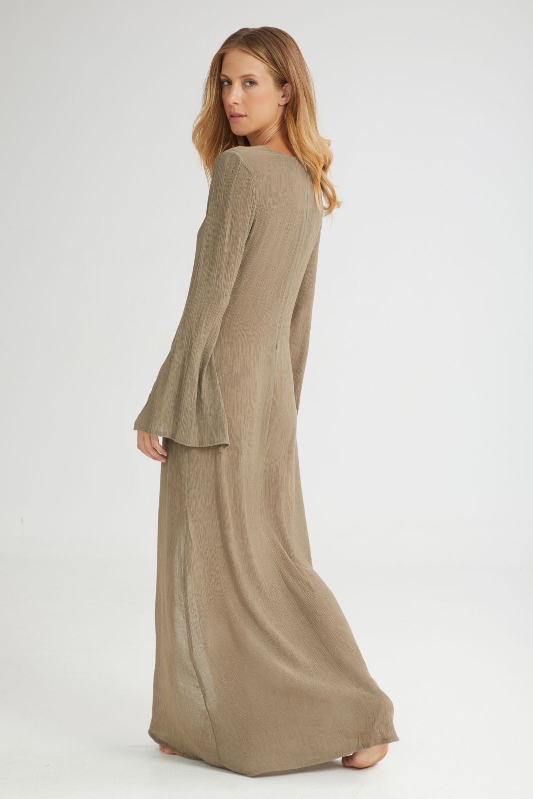 Woman wearing a long khaki dress on a white background
