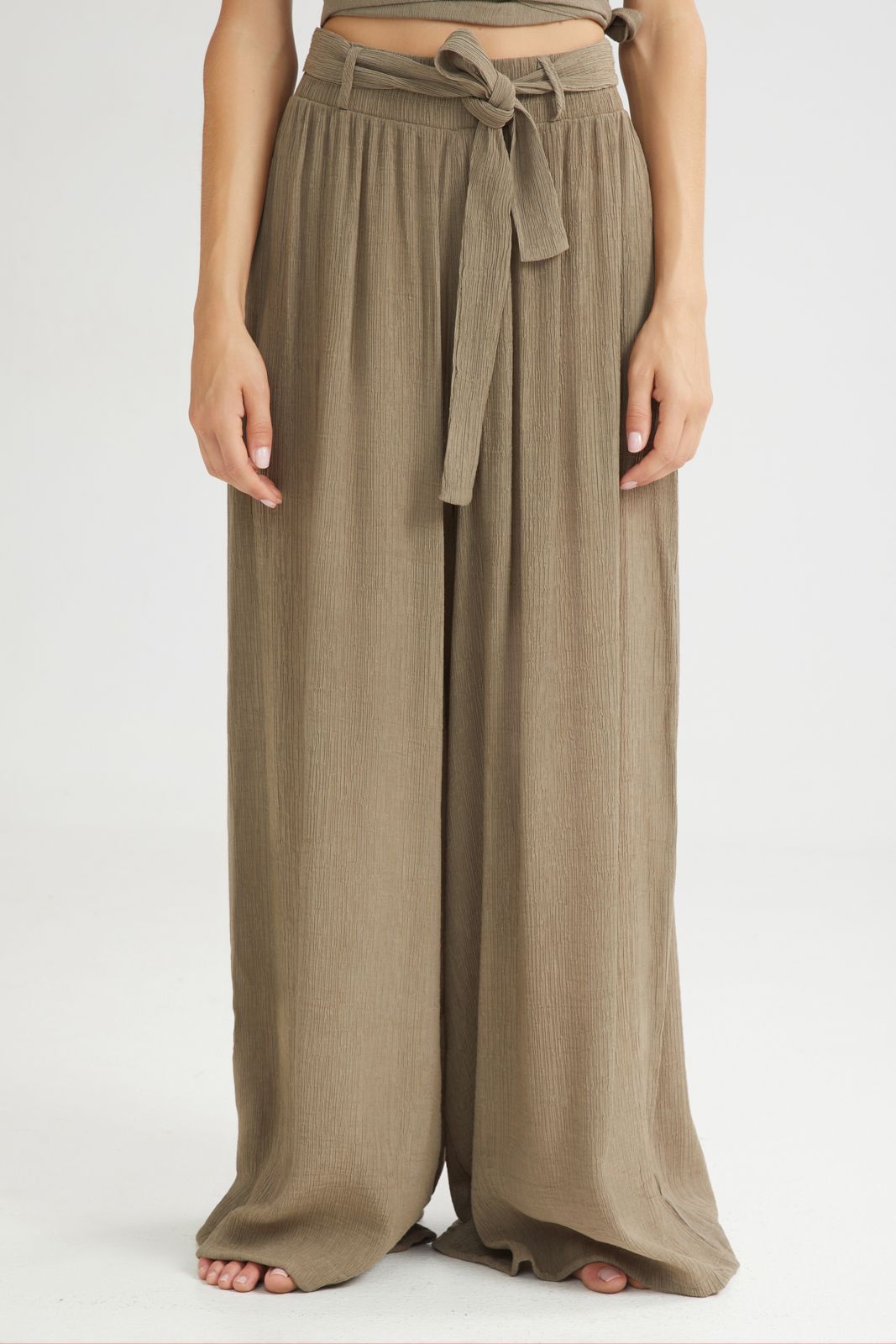 Brown wide-leg pants with a belt on a white background