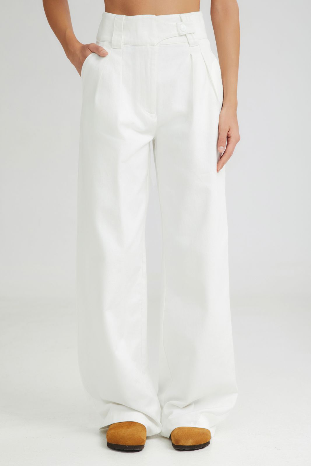 White wide-leg pants worn by a person on a white background
