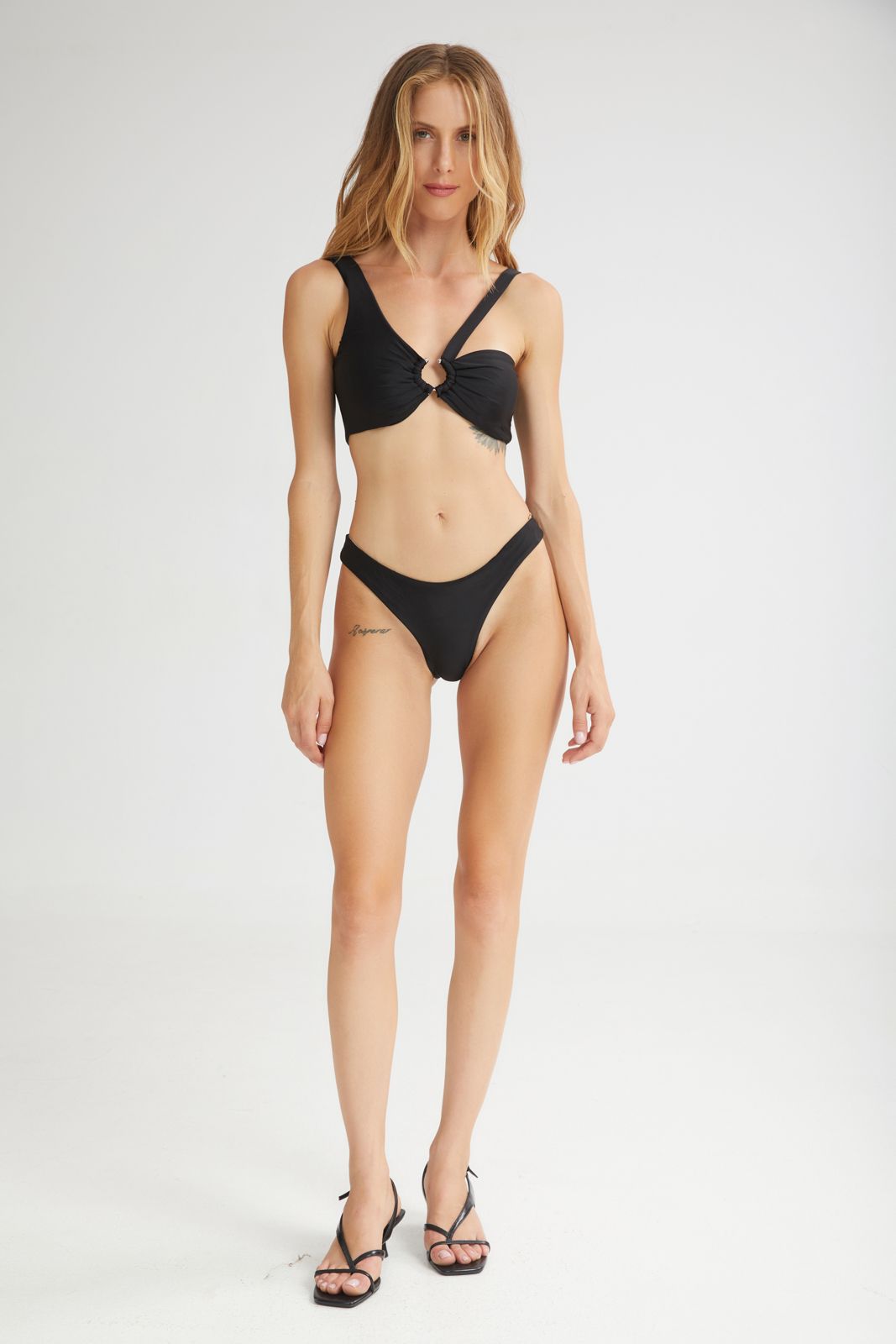 Woman wearing a black bikini on a white background