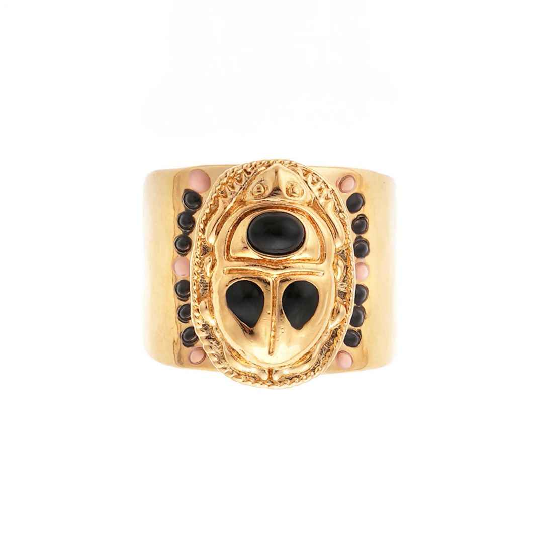 Gold ring with black and pink stones on a white background