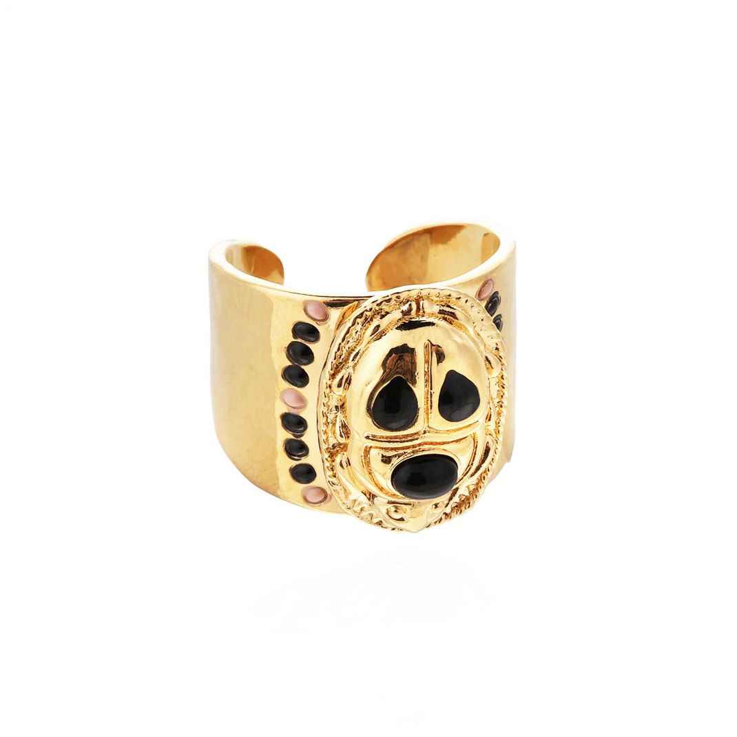 Gold ring with black gemstones on a white background