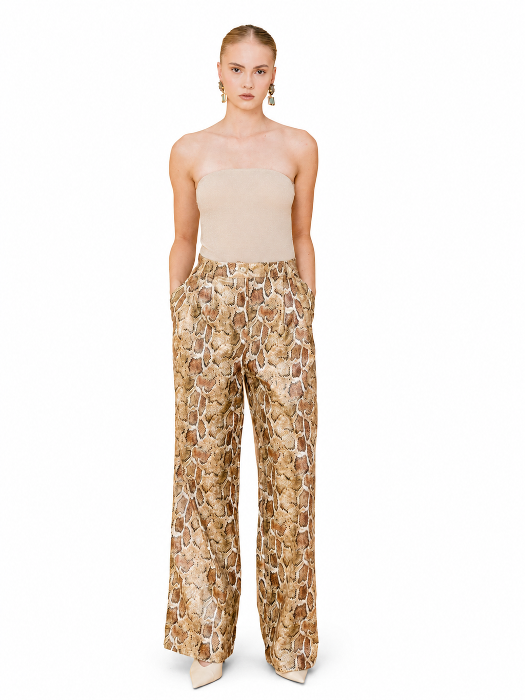 A model stands against a plain white background wearing a beige strapless tube top and high-waisted wide-leg trousers with a textured tan, brown, and beige animal-print pattern.