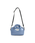 A light blue puffer-style shoulder bag with a black shoulder strap and a white brand label reading 'WOOF' on the front, shown on a plain white background.
