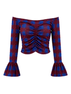 An off-the-shoulder long-sleeve crop top with a red and blue plaid pattern, featuring a ruched center front and flared bell sleeves.