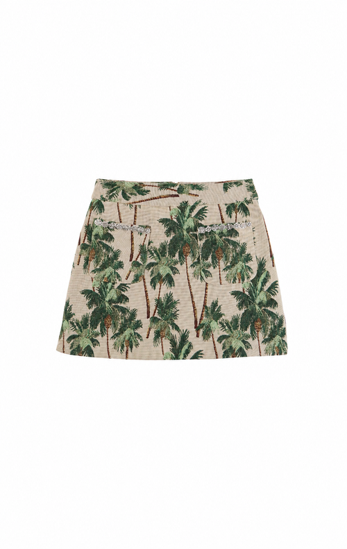 A beige mini skirt with an all-over green palm tree print, featuring two front patch pockets with silver-tone chain accents, shown flat on a white background.