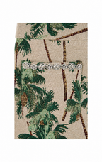 A close-up of a woven fabric featuring a green palm tree pattern on a beige background, with a horizontal row of silver rhinestone embellishments across the center.