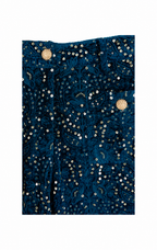 A close-up of a dark teal blue velvet fabric adorned with intricate gold sequins and beadwork, featuring two prominent round gold embellishments near the top.