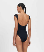 Woman wearing a black swimsuit on a white background