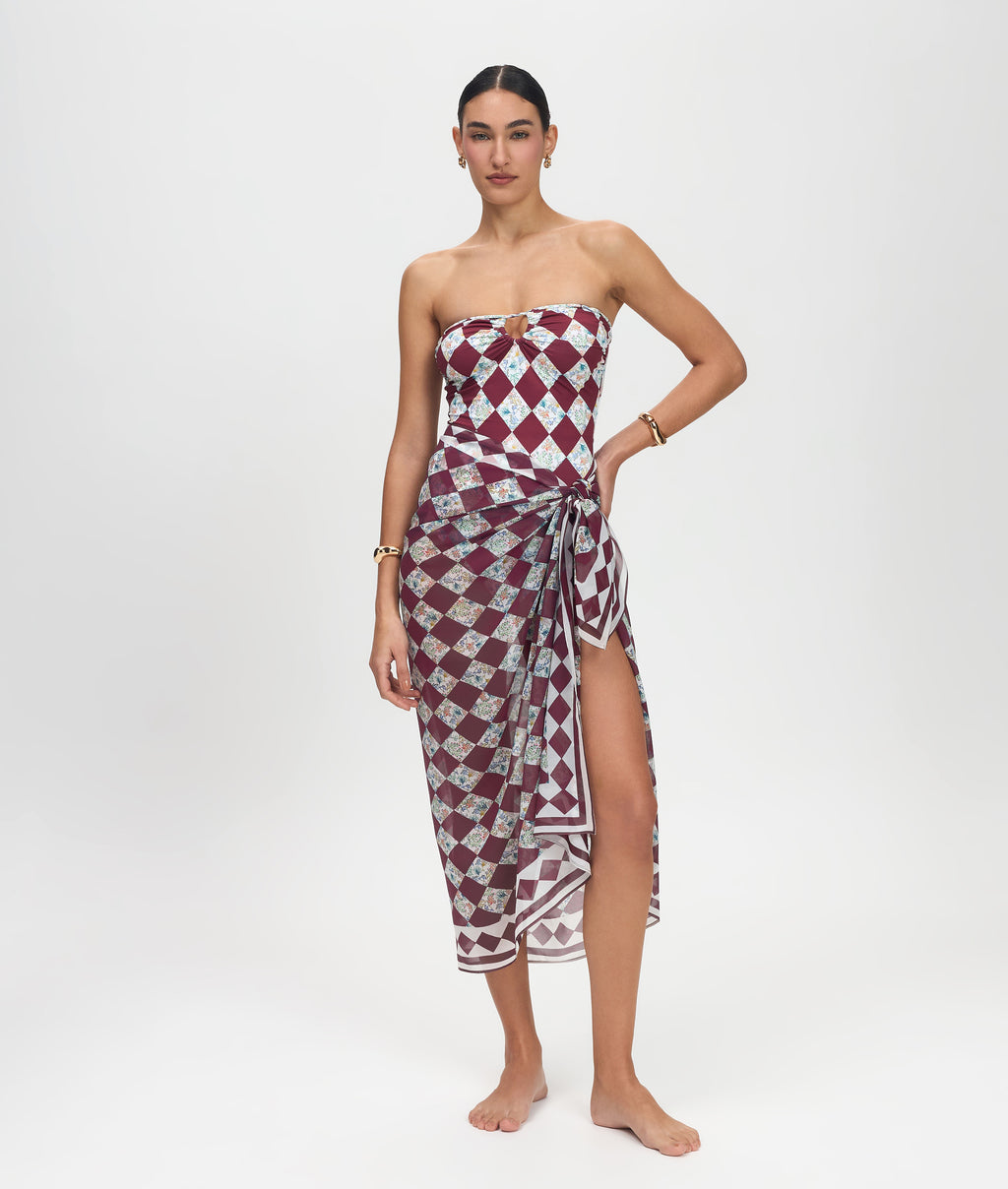 Woman wearing a strapless dress with a geometric pattern on a white background