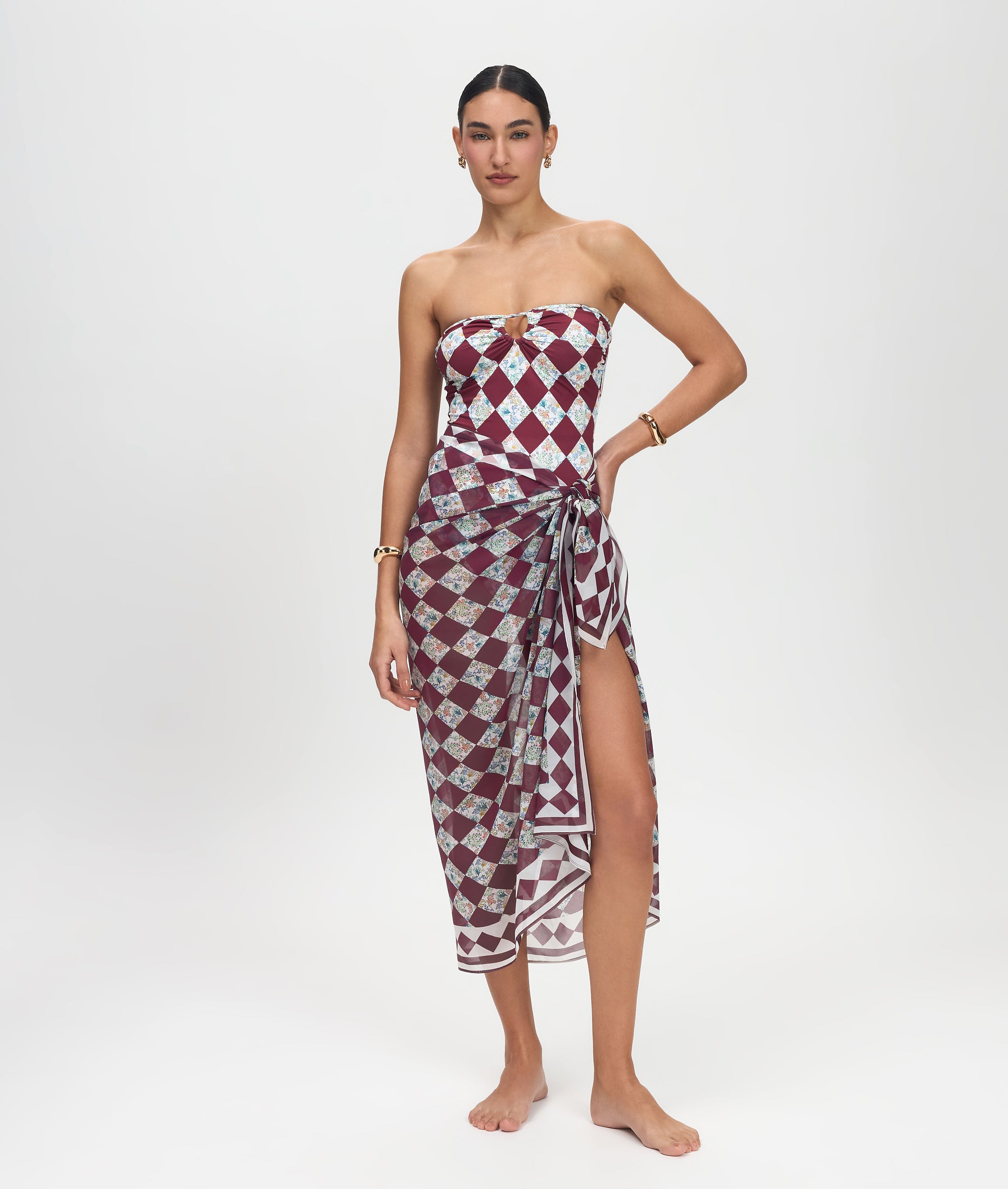 Woman wearing a strapless dress with a geometric pattern on a white background