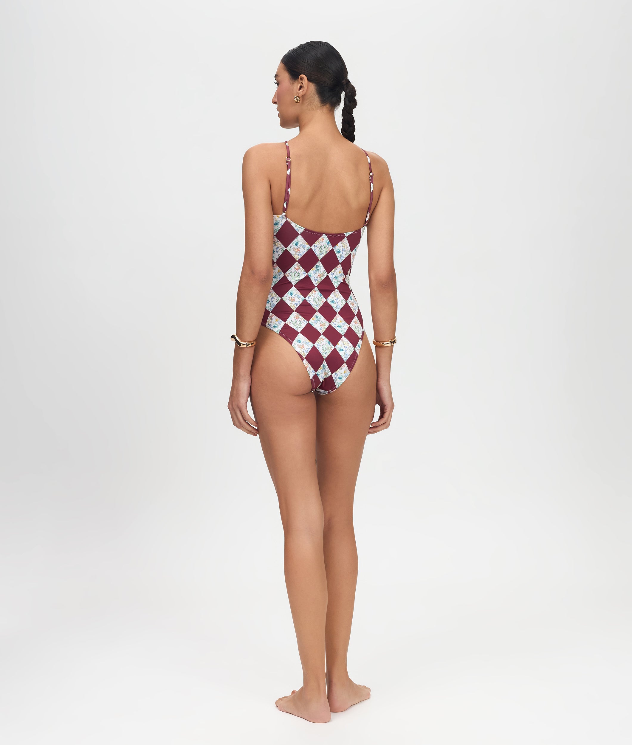 Woman wearing a red and white checkered swimsuit on a white background