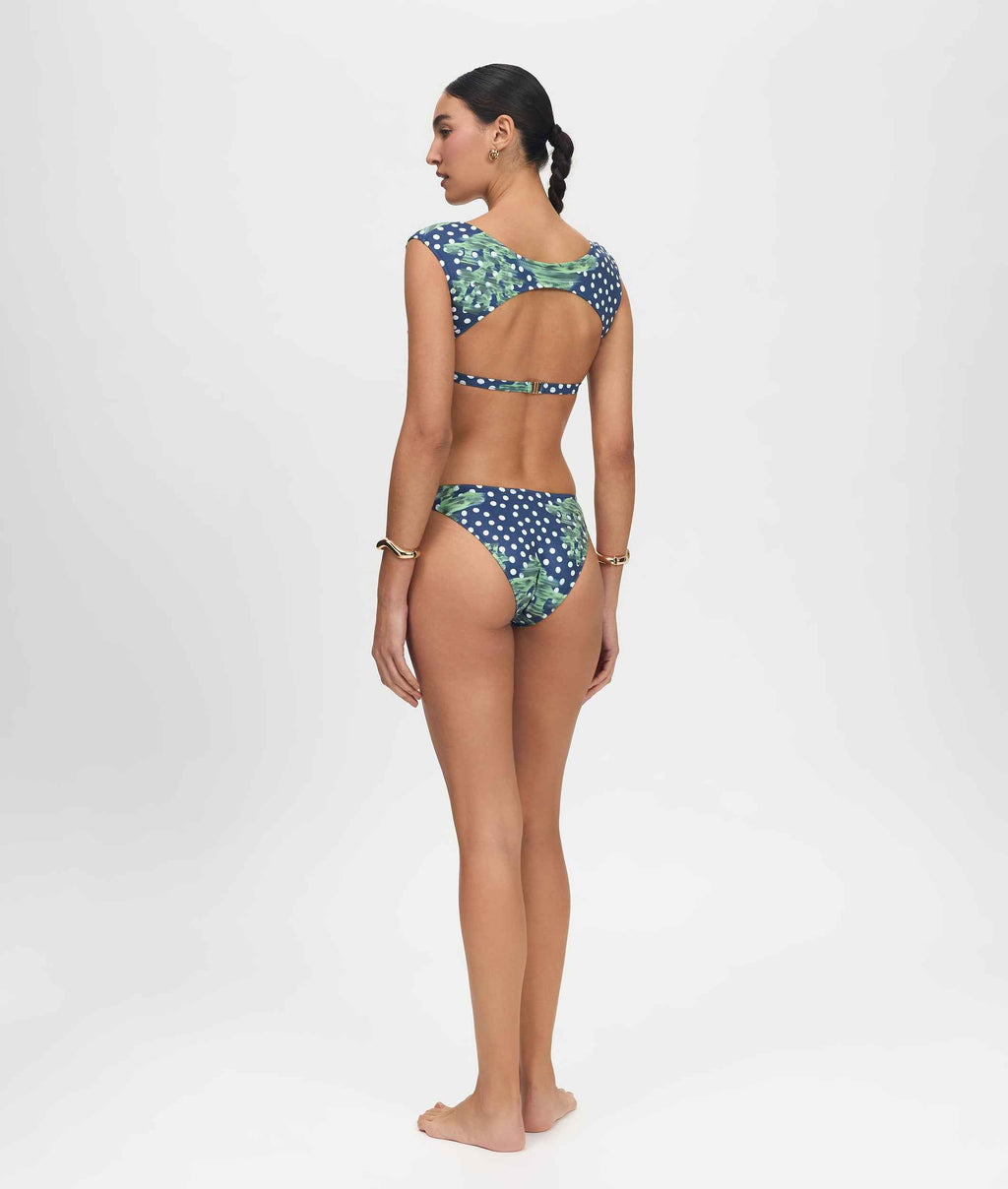 Woman wearing a patterned bikini on a white background