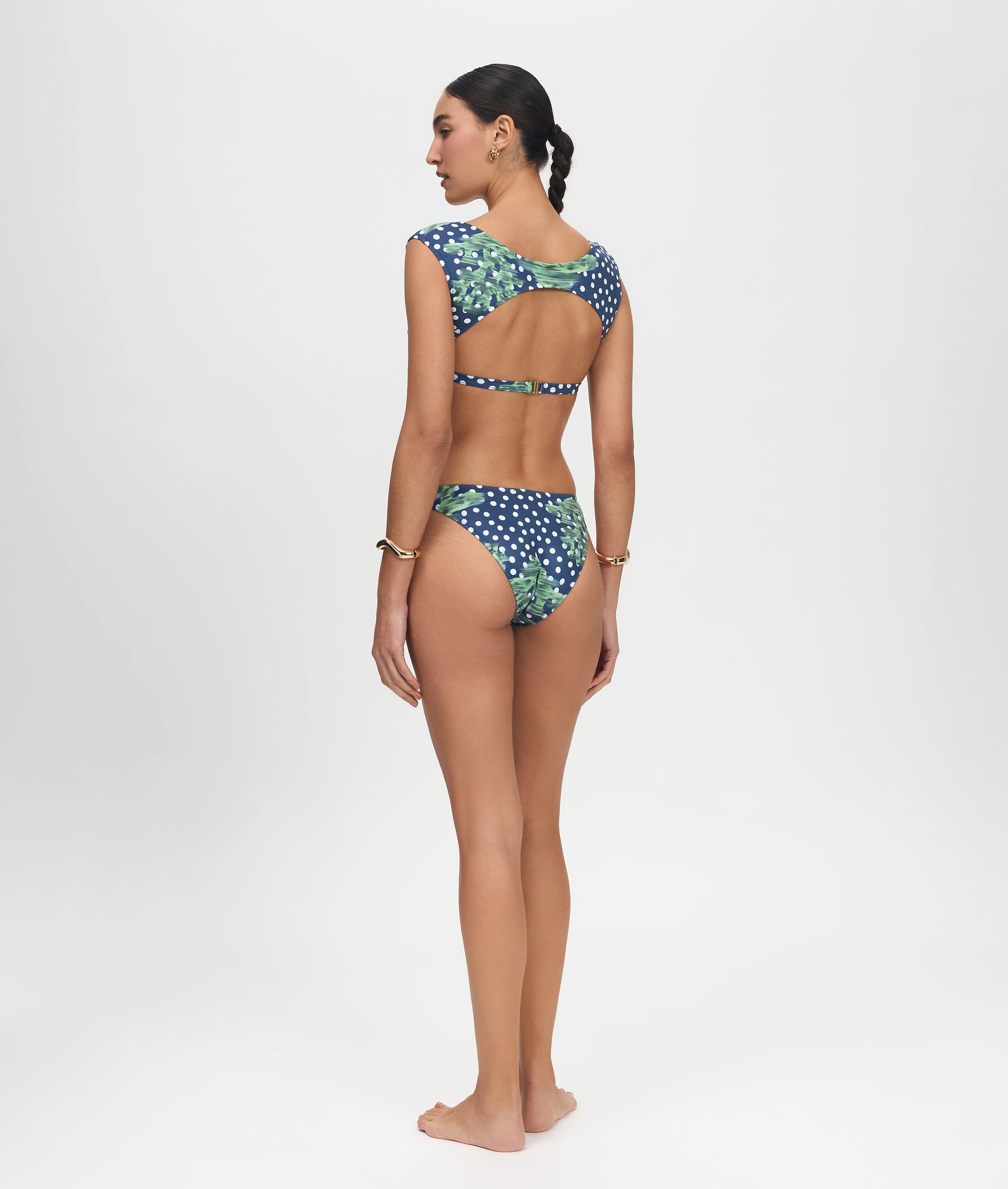 Woman wearing a patterned bikini on a white background