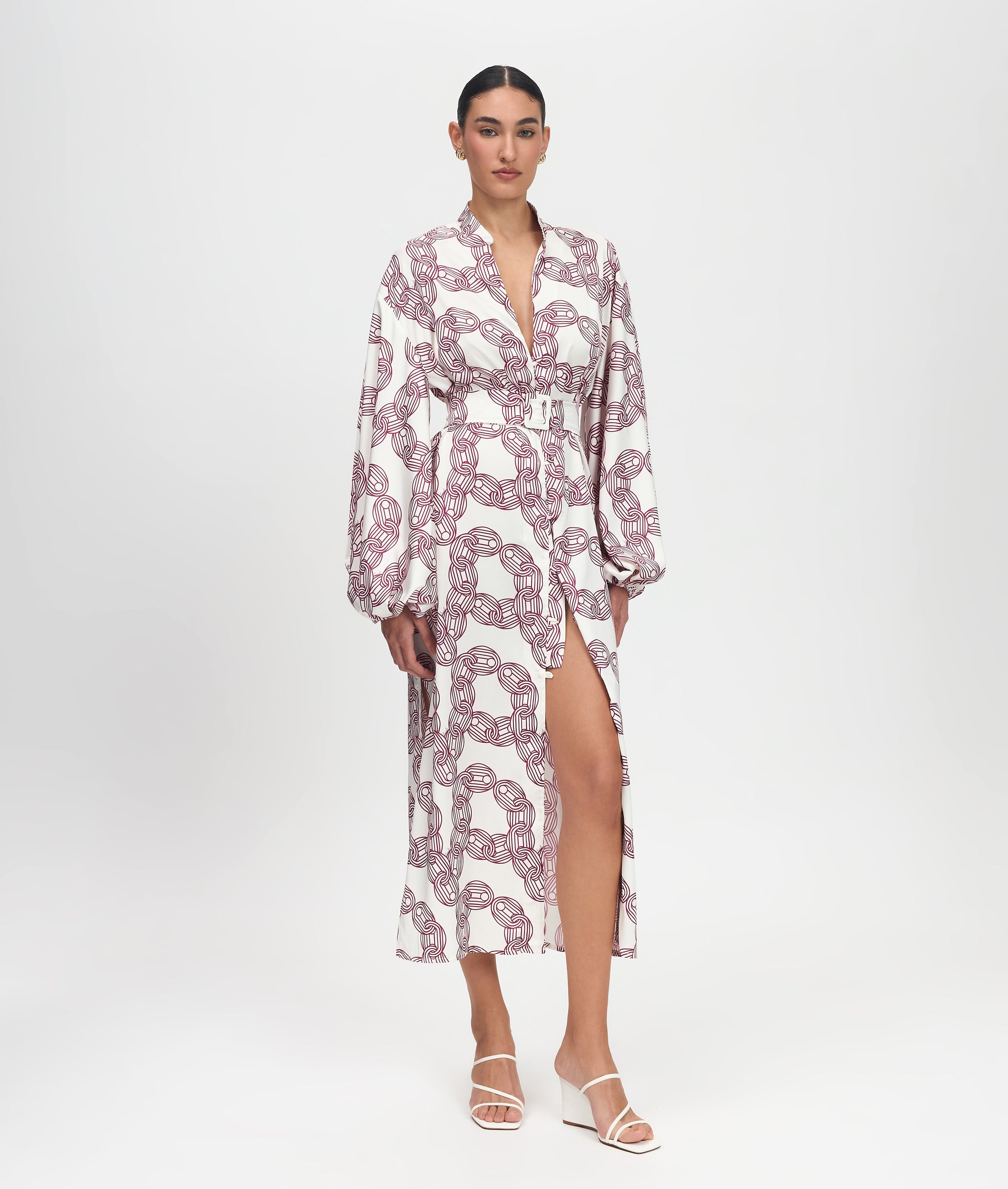 Woman wearing a patterned dress on a white background