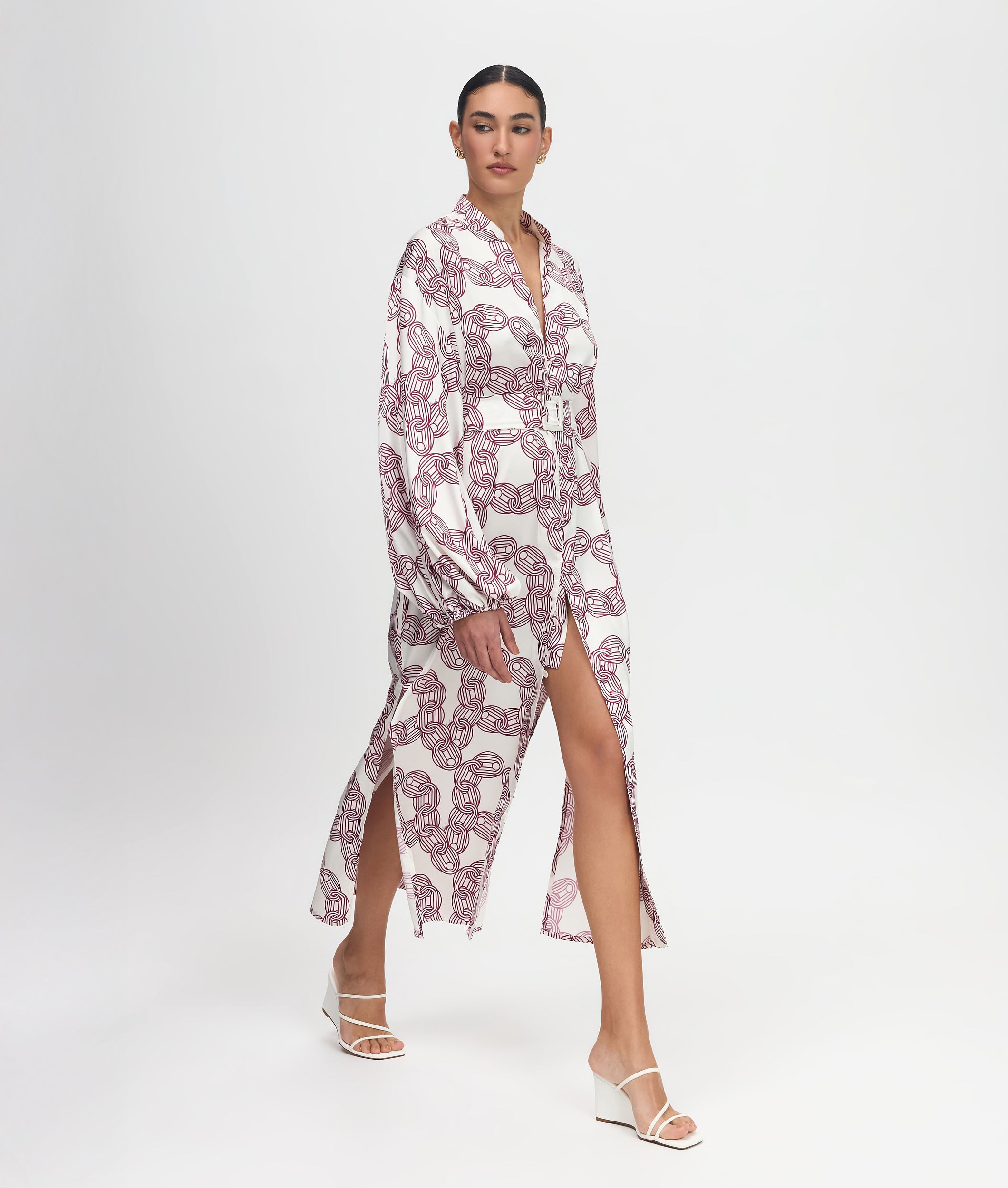 Woman wearing a patterned dress on a white background