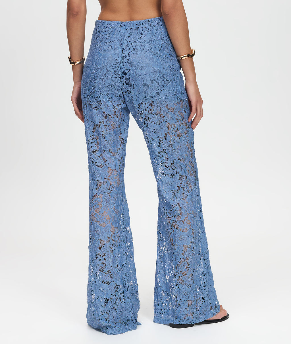 Blue lace pants worn by a person on a white background
