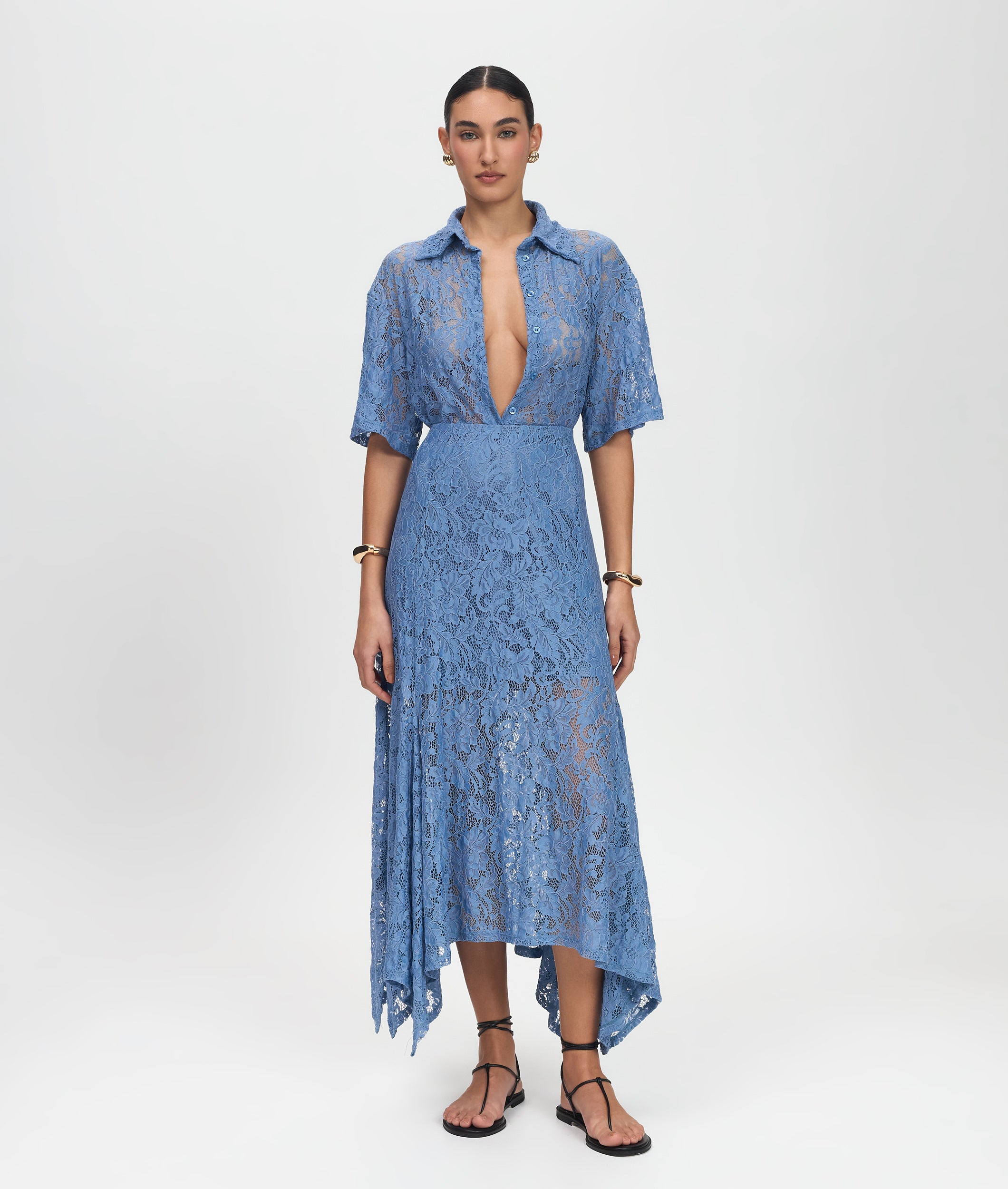 Woman wearing a blue lace dress on a white background