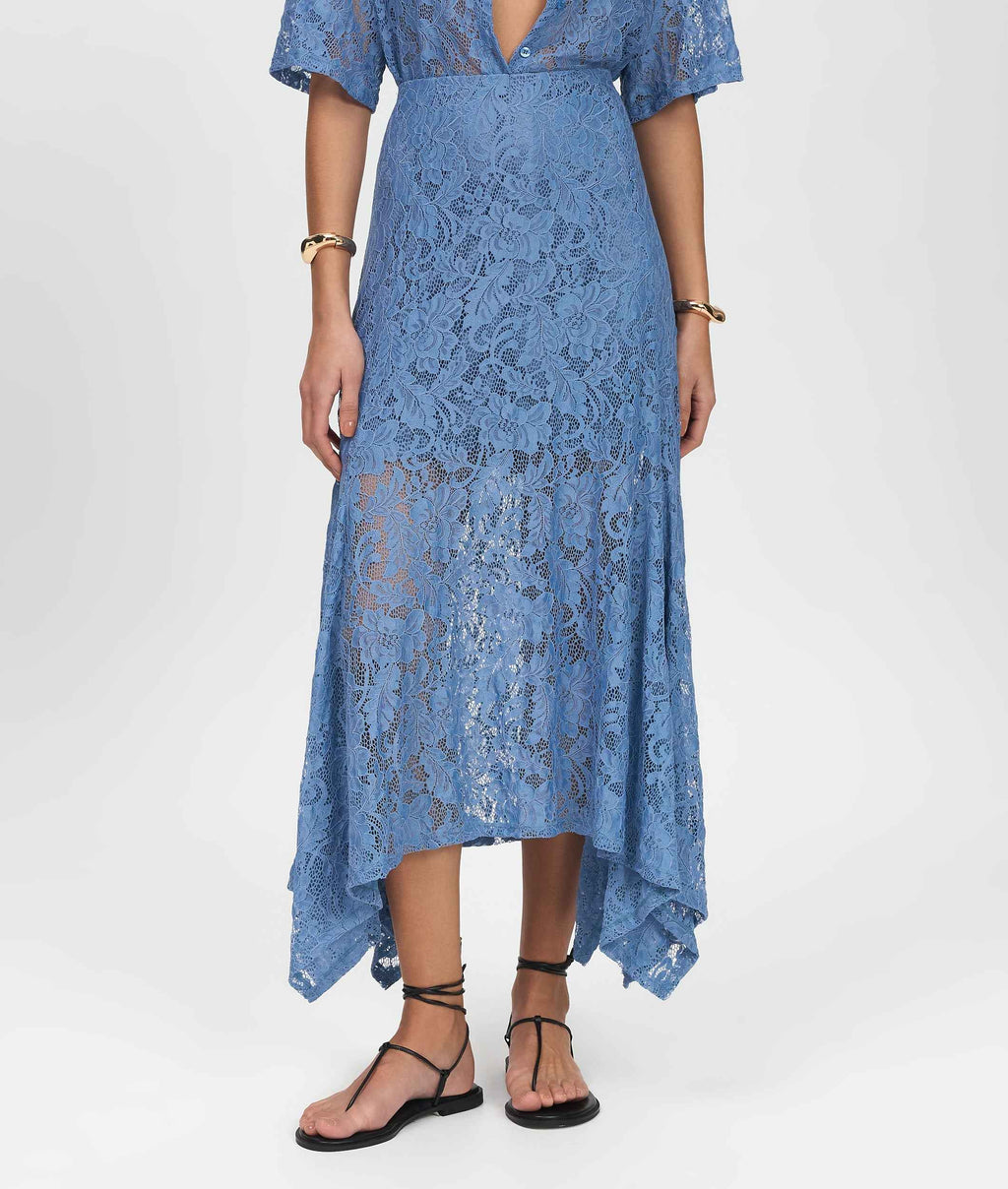 Blue lace dress worn by a person on a white background