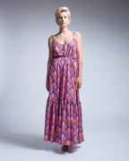 Woman wearing a floral dress on a plain background
