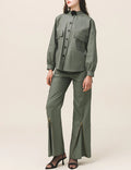 A person viewed from the back wearing green cargo pants with a button and zipper closure, and a matching green shirt.