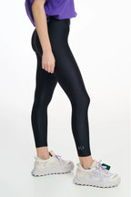 Person wearing black leggings with a white background