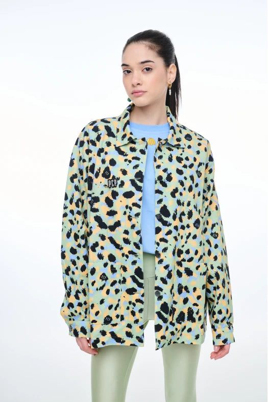 Person wearing a colorful leopard print jacket on a white background