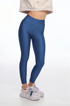 Person wearing blue leggings with a white background