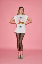 Woman wearing a white t-shirt with a graphic design on a pink background