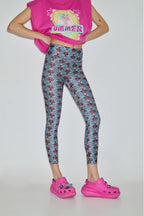Person wearing a pink sleeveless top with 'Summer' text, floral leggings, and pink shoes on a white background