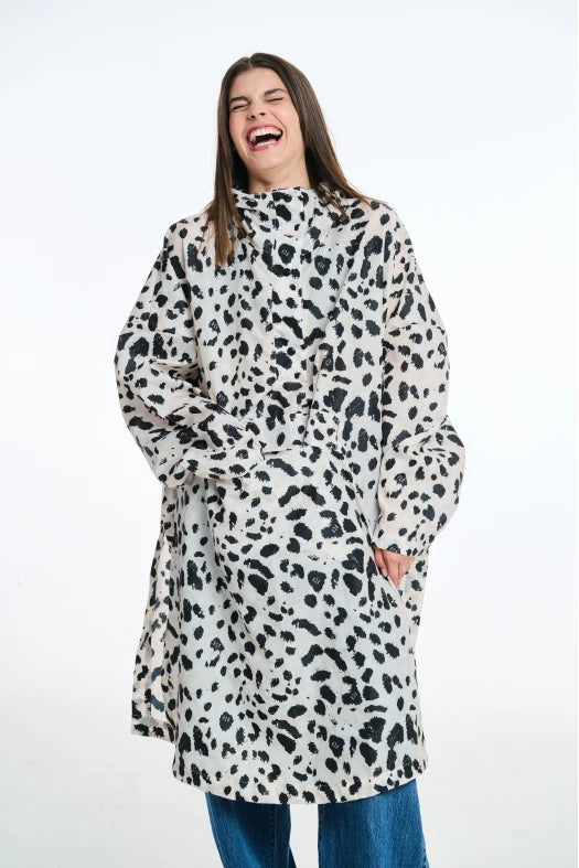 Person wearing a long, patterned coat on a white background